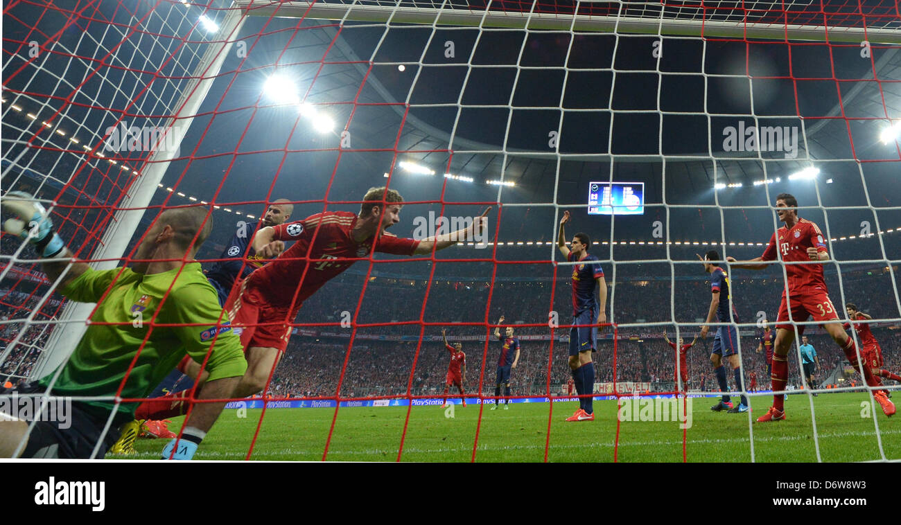 Munich's Thomas Mueller (2.L.) jubilates  as he scores the 1:0 against Barcelonas Gerard Pique (L), Marc Bartra (3.R.), Sergio Busquets and Munichs Mario Gomez (R) during the UEFA Champions League semi final first leg soccer match between FC Bayern Munich and FC Barcelona at the Arena in Munich, Germany, 23 April 2013. Photo: Peter Kneffel/dpa +++(c) dpa - Bildfunk+++ Stock Photo