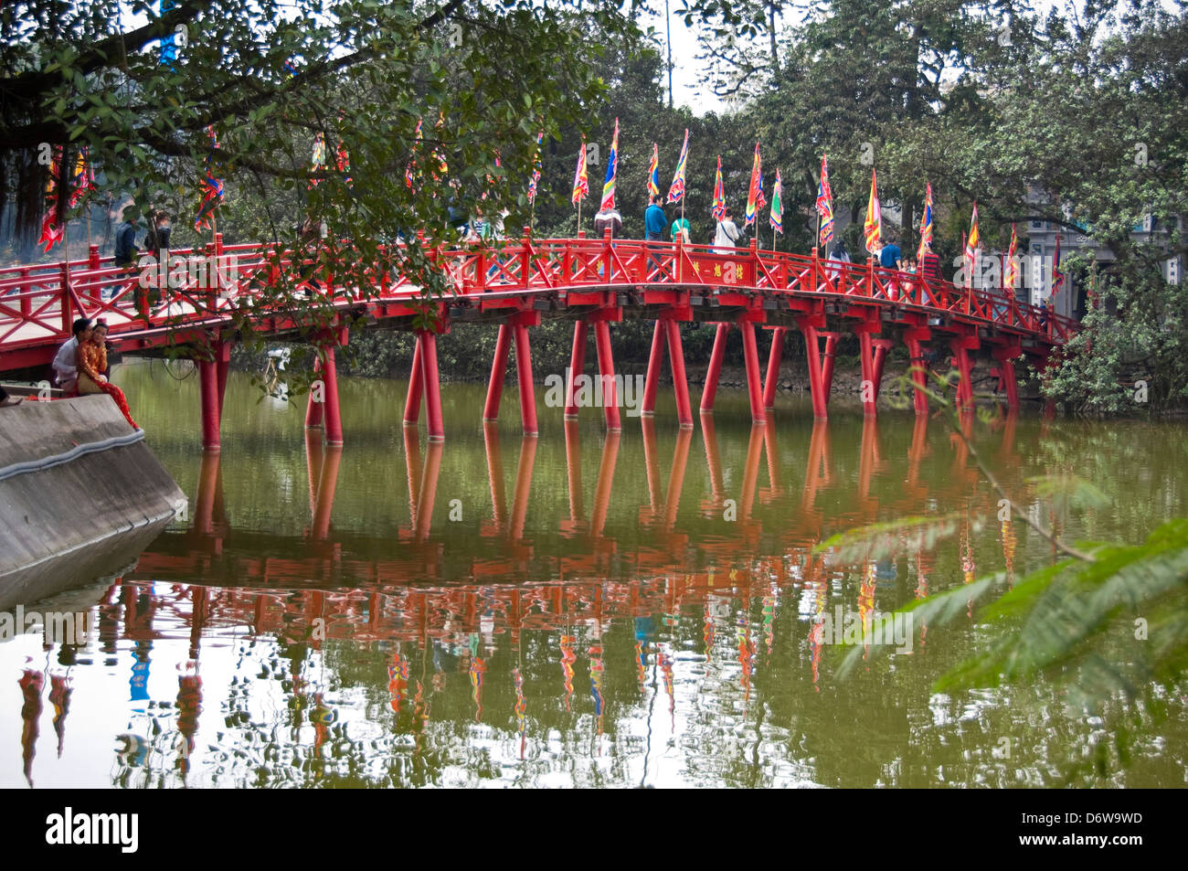 Horizontal wide angle view of The Huc bridge, Thê Húc bridge crossing Hoan Kiem Lake in Hanoi. Stock Photo