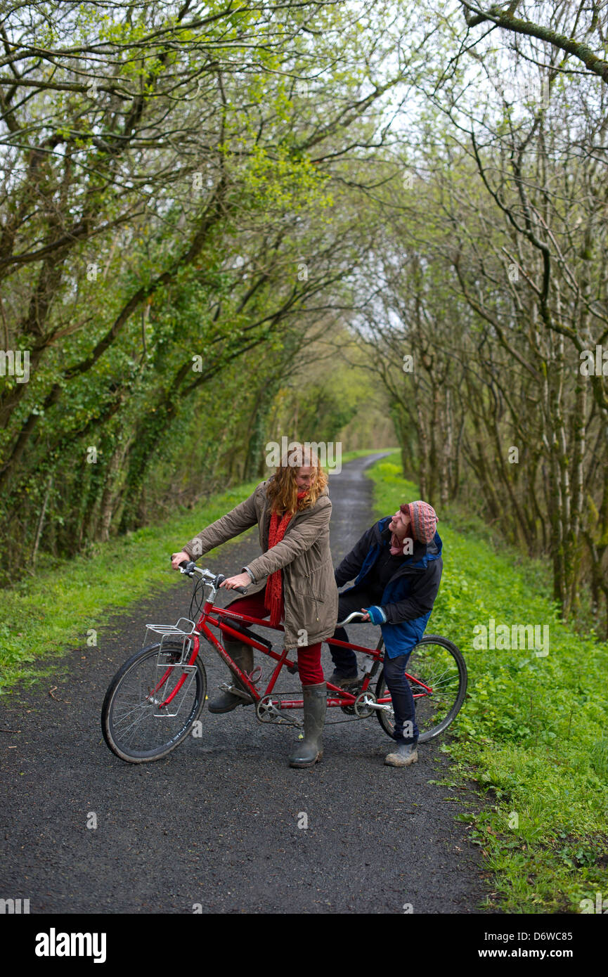 The Tarka Trail, in North Devon, between Torrington and East Yard. Two ladies on a tandem bicycle on part of the Tarka Trail. Stock Photo