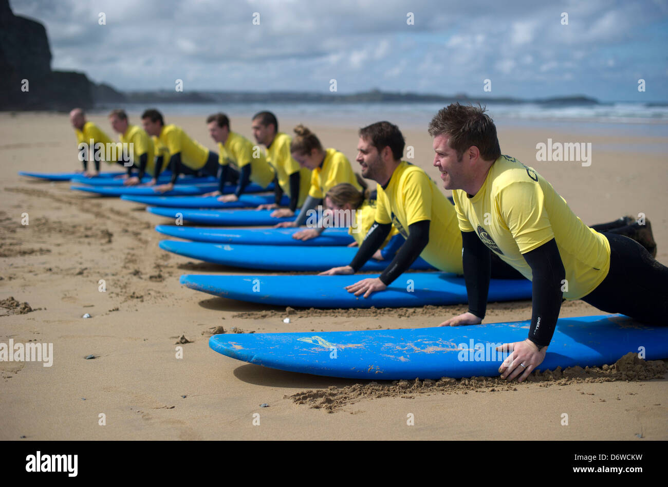 Students during a surf lesson on the beach at Watergate Bay, Cornwall, UK Stock Photo