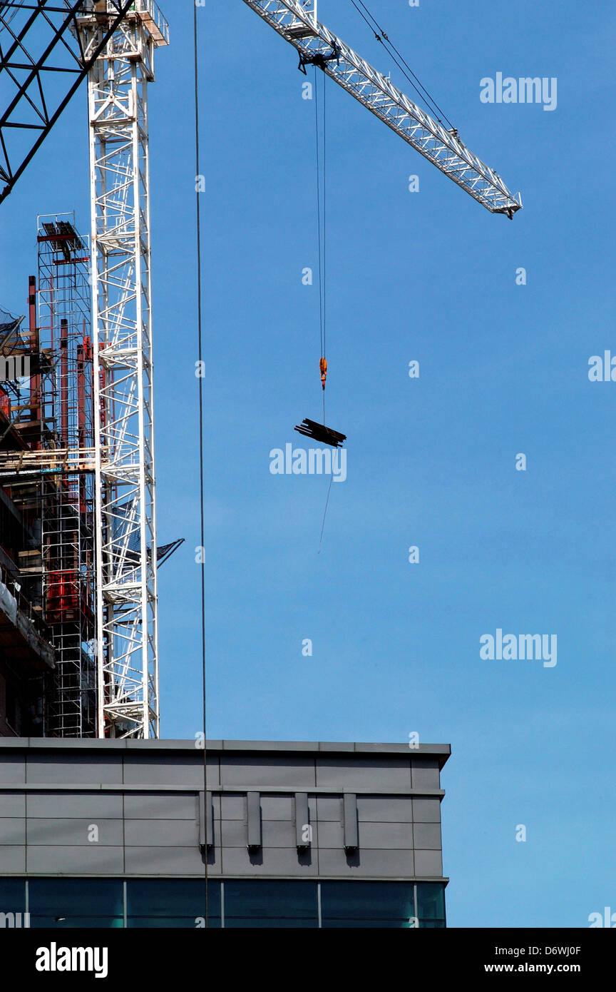 Crane lifting a steel beam at construction site, New York City, New ...