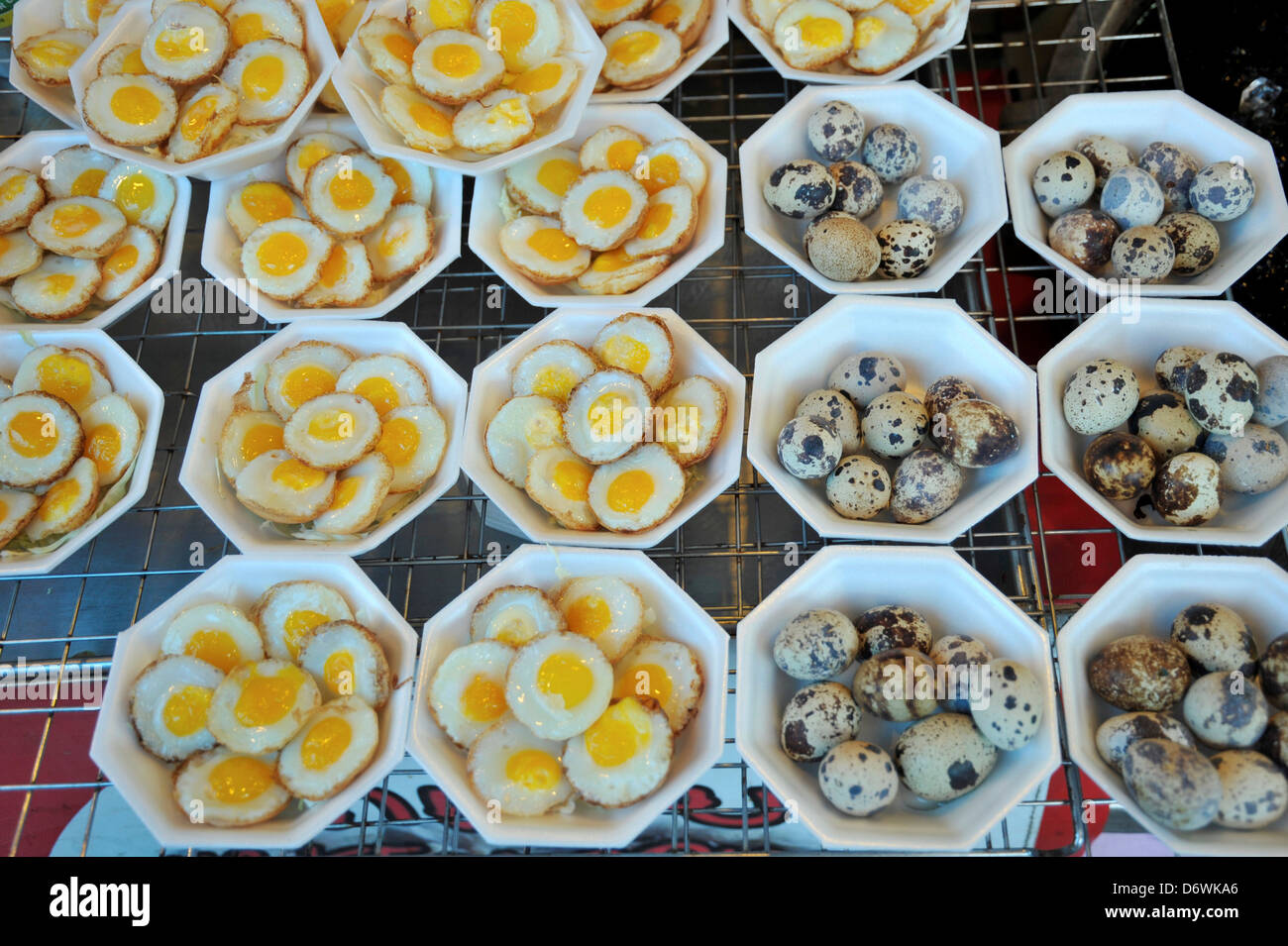 Thailand, Khon kaen, Quail Eggs, popular Thai snack, raw at right and