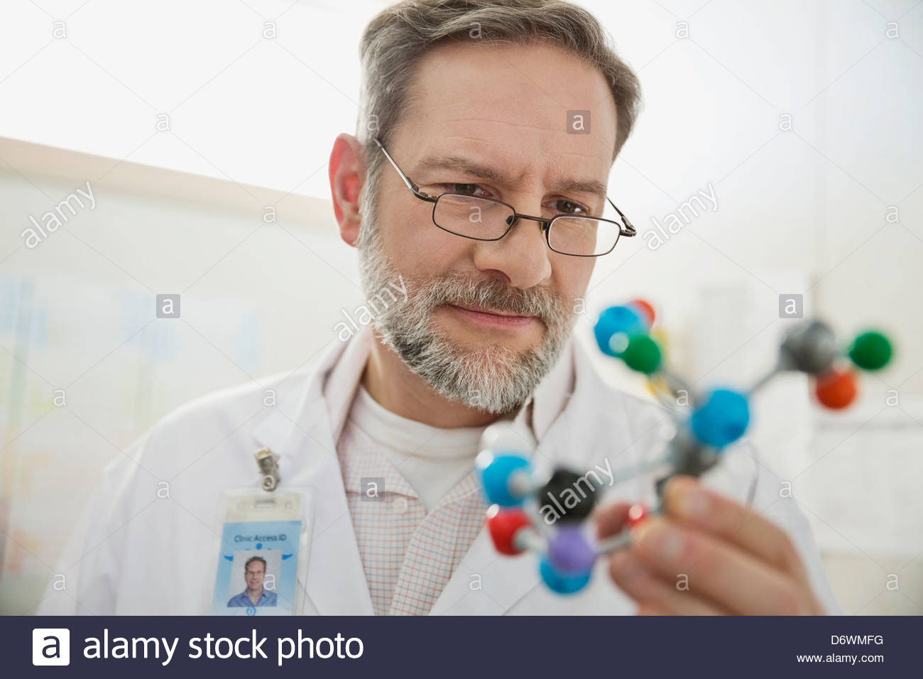 Mature male doctor analyzing molecular model in lab Stock Photo