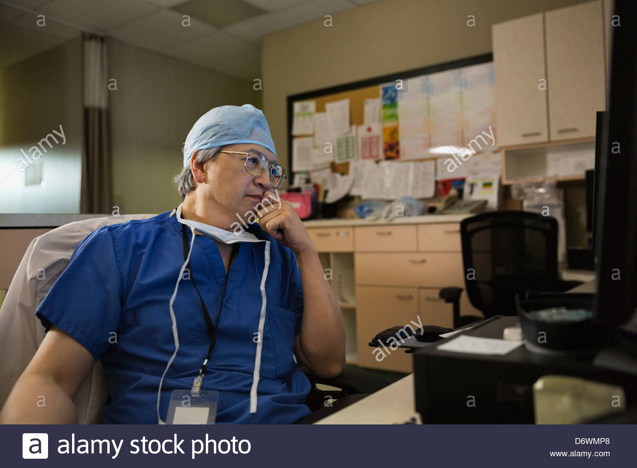 Thoughtful senior male surgeon in clinic Stock Photo