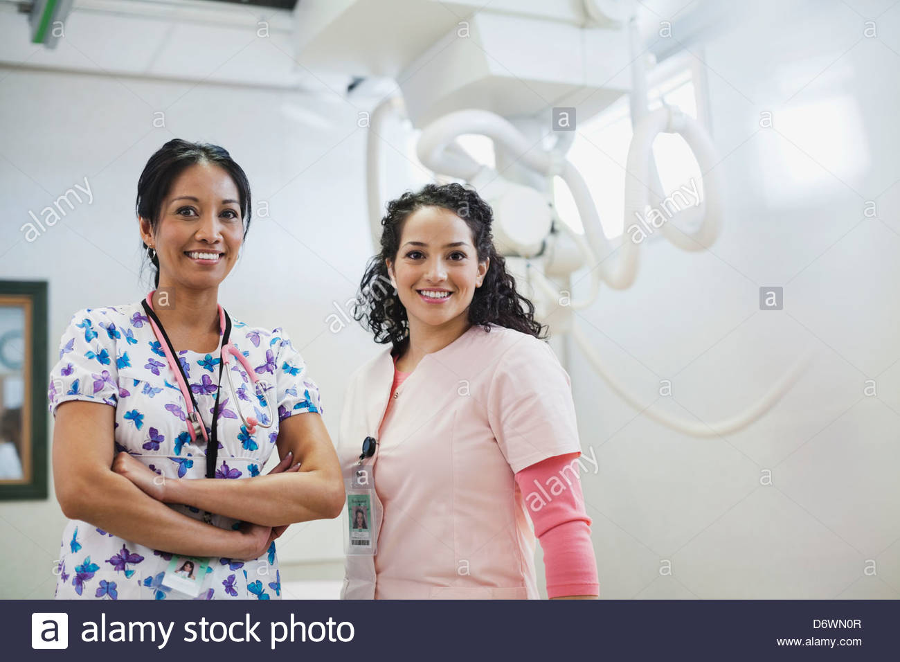 Portrait of happy female medical professionals in examination room Stock Photo