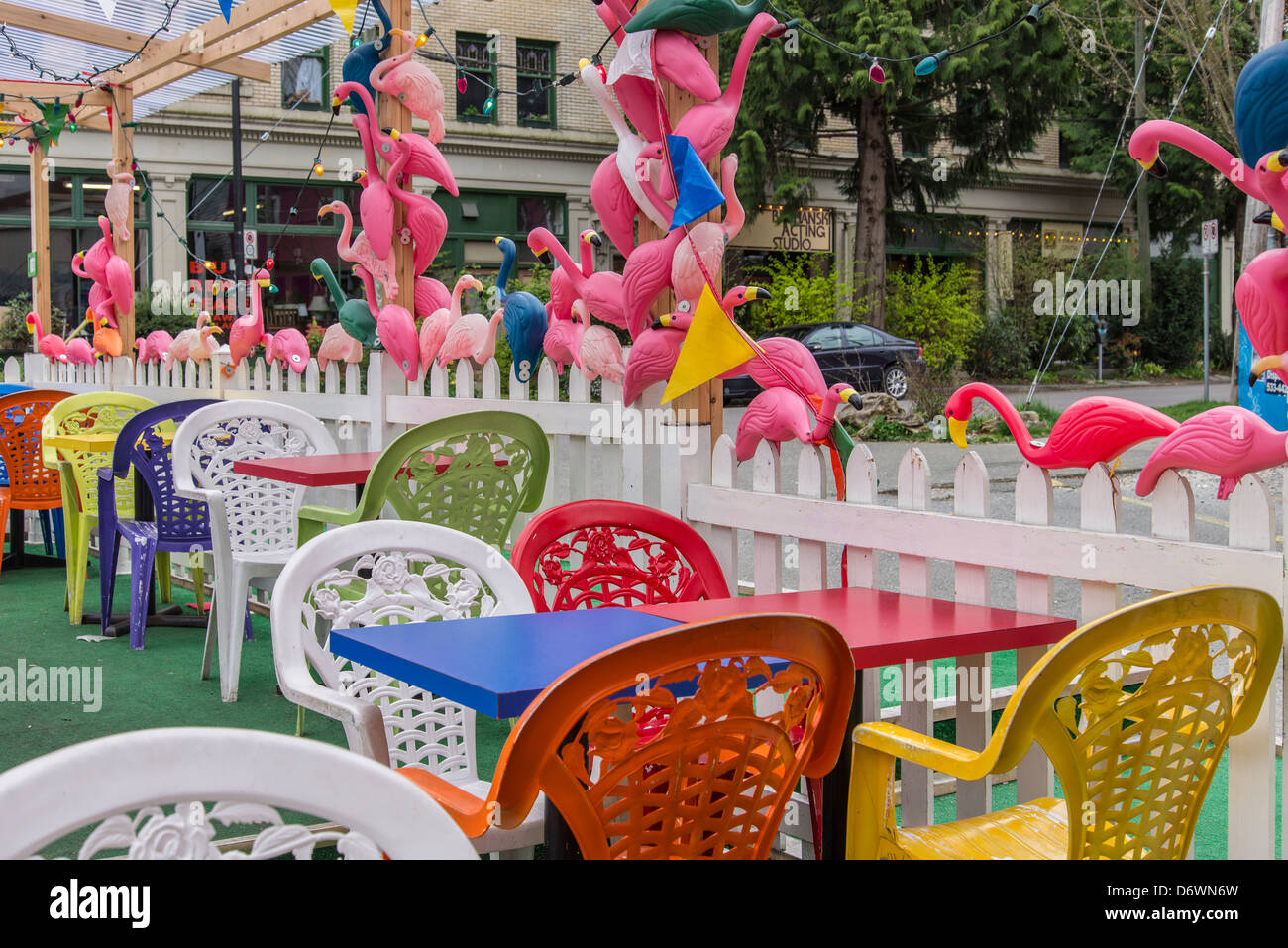 Pink flamingoes surround outdoor cafe patio, Main Street, Vancouver