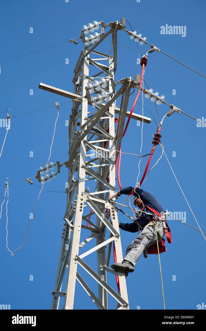 man at work, pylon, high voltage, electricity, vulci, lazio, italy, europe Stock Photo