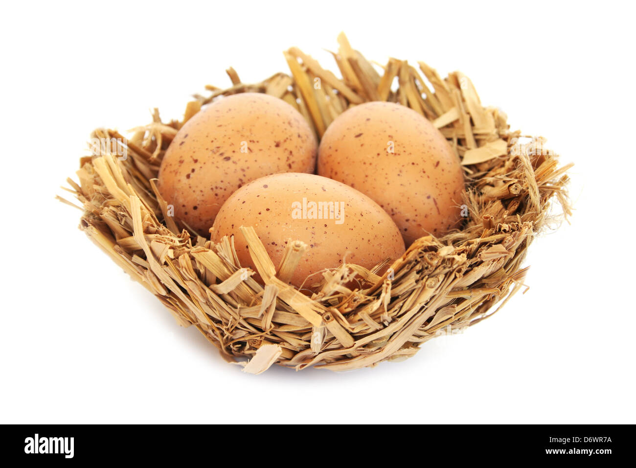 Easter eggs nest isolated on white background Stock Photo - Alamy