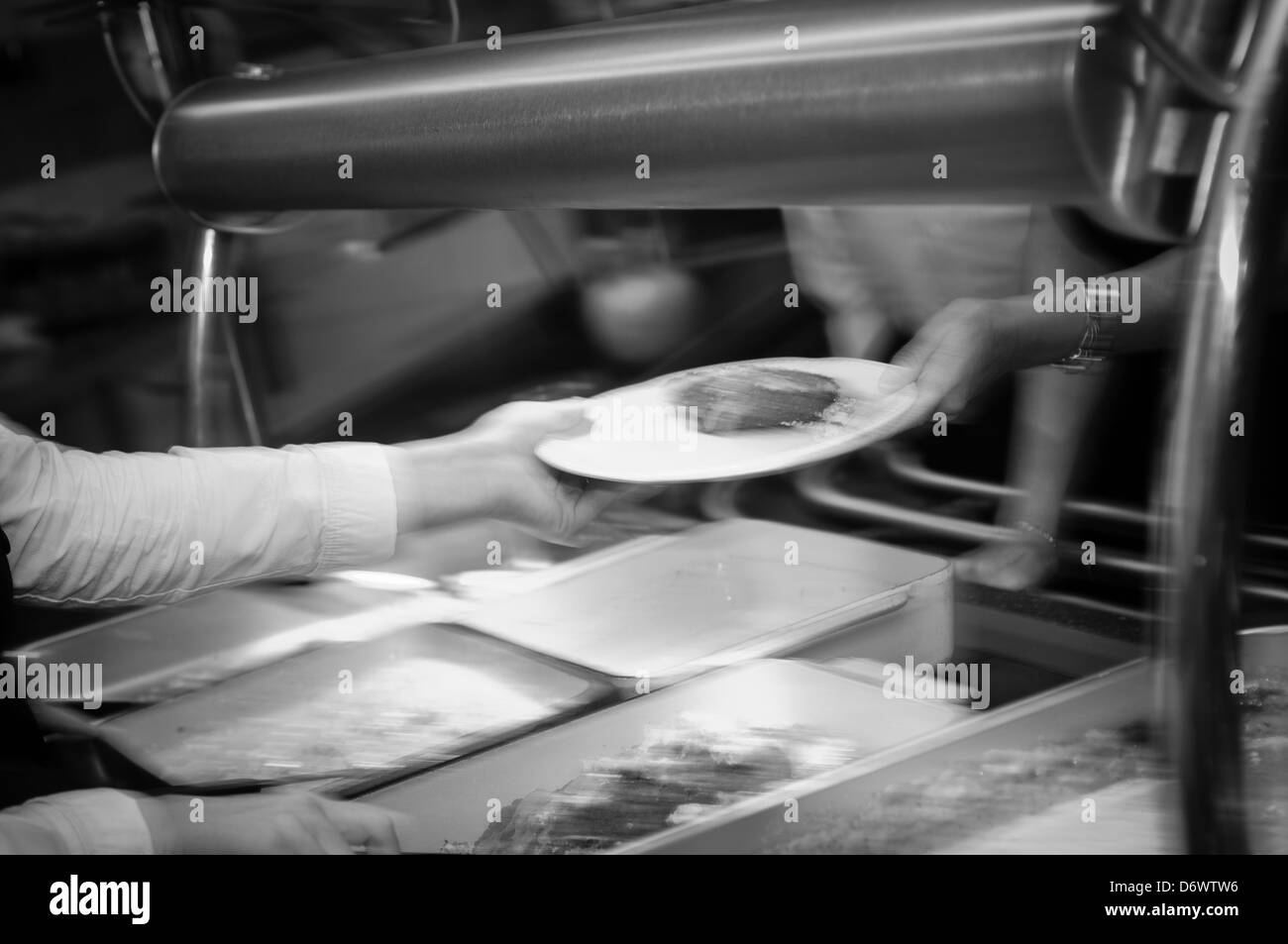 Blurred image of caterers serving hot food in a canteen Stock Photo Alamy