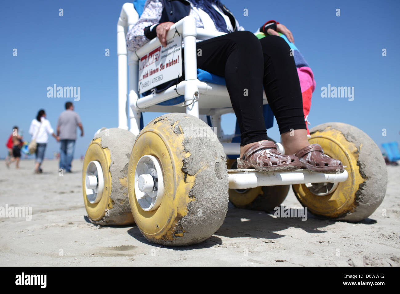 Sankt Peter-Ording, Germany, Senior in beach wheelchair on the beach of St. Peter-Ording Stock Photo
