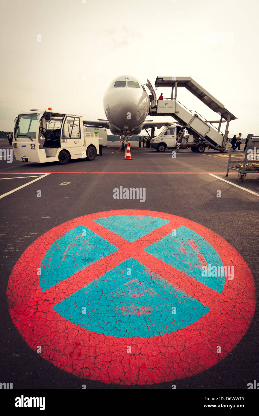 Adria Airways plane waiting for passengers with no parking sign in front of the plane Stock Photo