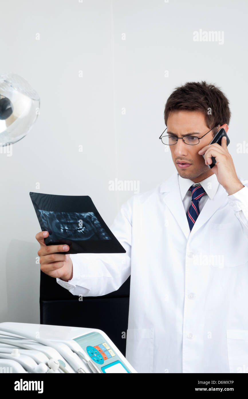 Dentist On Call As He Checks XRay Report Stock Photo Alamy