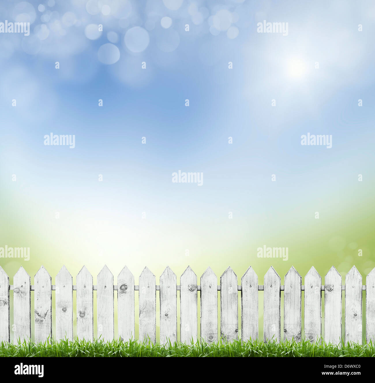 old white fence on a background of blue sky. bokeh Stock Photo