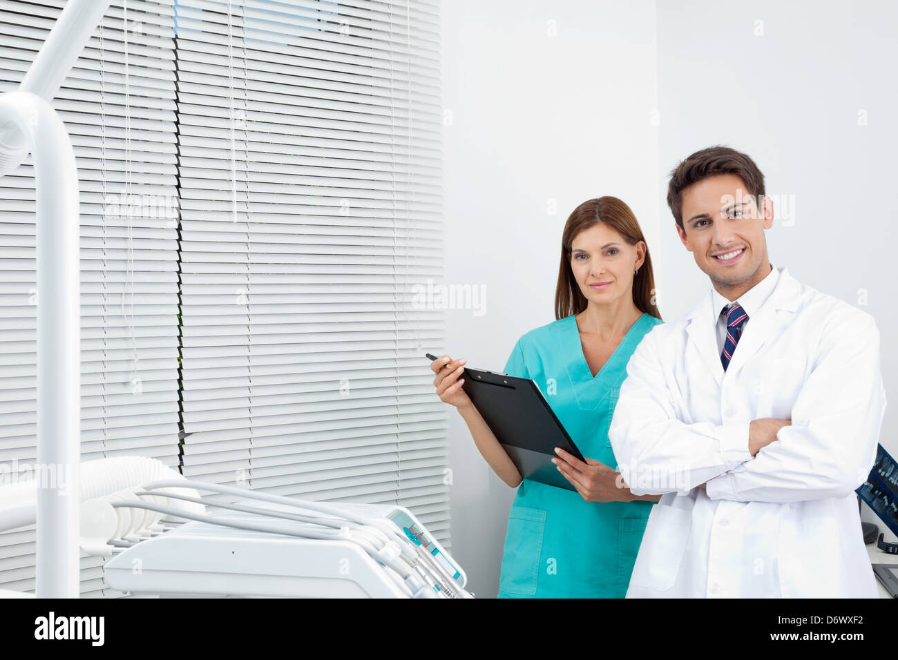 Doctor And Female Assistant In Dental Clinic Stock Photo