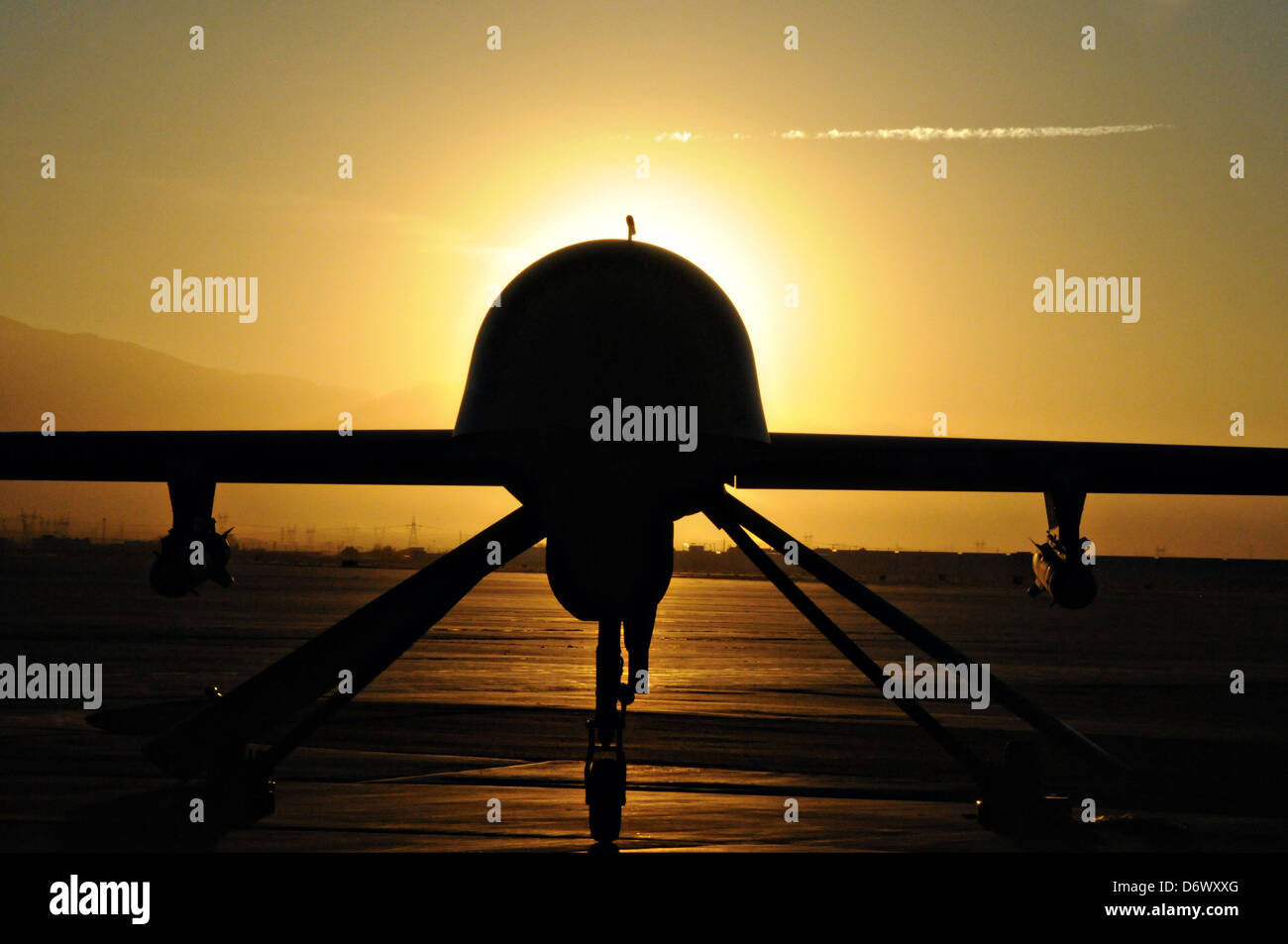 US Air Force MQ-1 Predator unmanned aerial vehicle assigned to the California Air National Guard's 163rd Reconnaissance Wing silhouetted during sunset at the Southern California Logistics Airport January 7, 2012 in Victorville, CA. Stock Photo