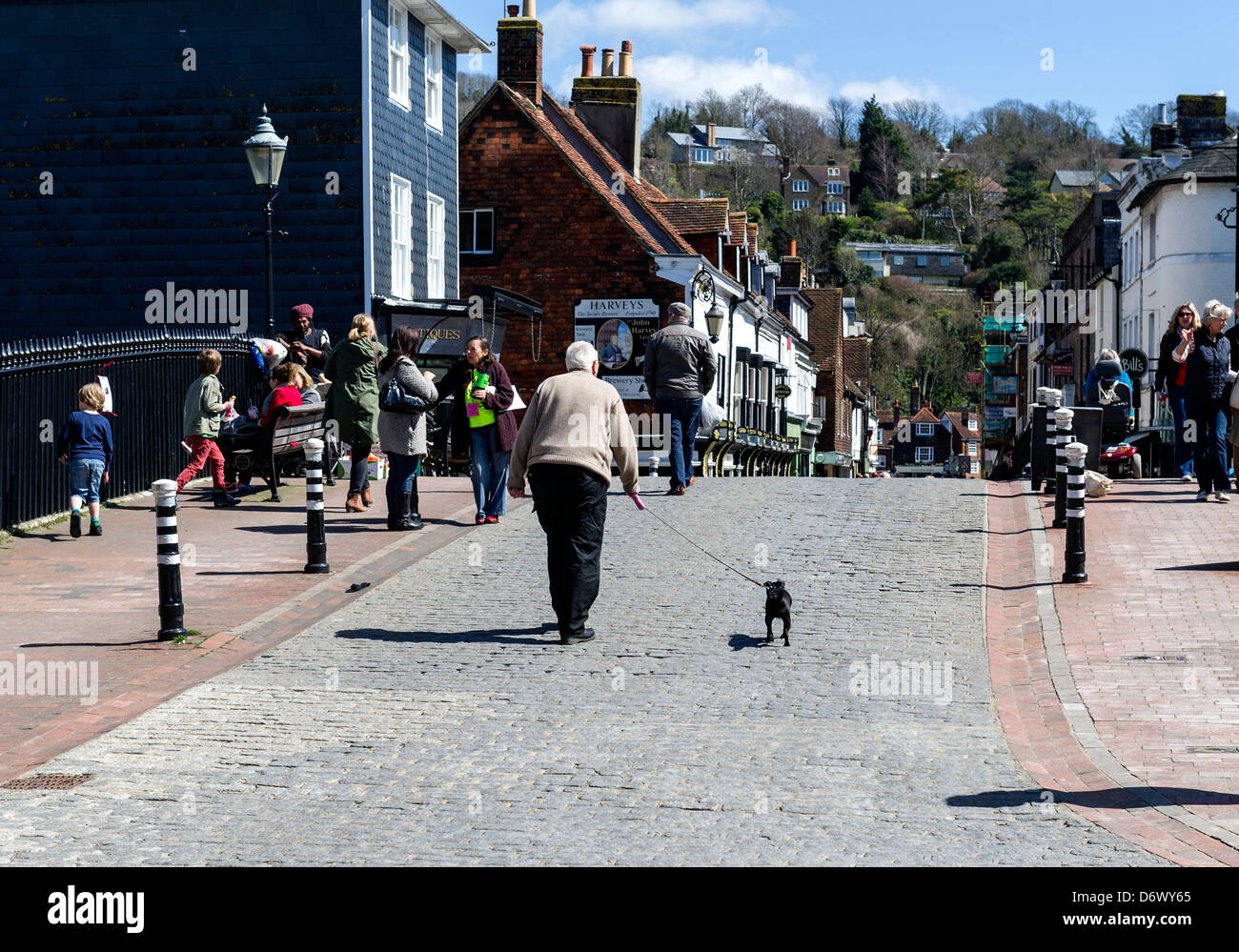 A man and his small dog walking over Cliffe Bridge in Lewes. Stock Photo
