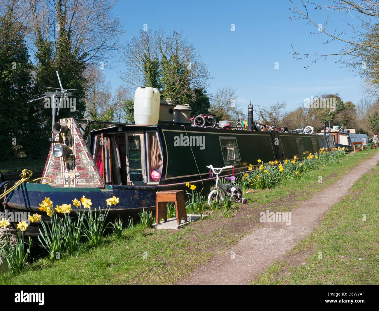 A Narrow boat and child's bicycle on the Grand Union Canal at Marsworth, Aylesbury, Bucks, UK Stock Photo