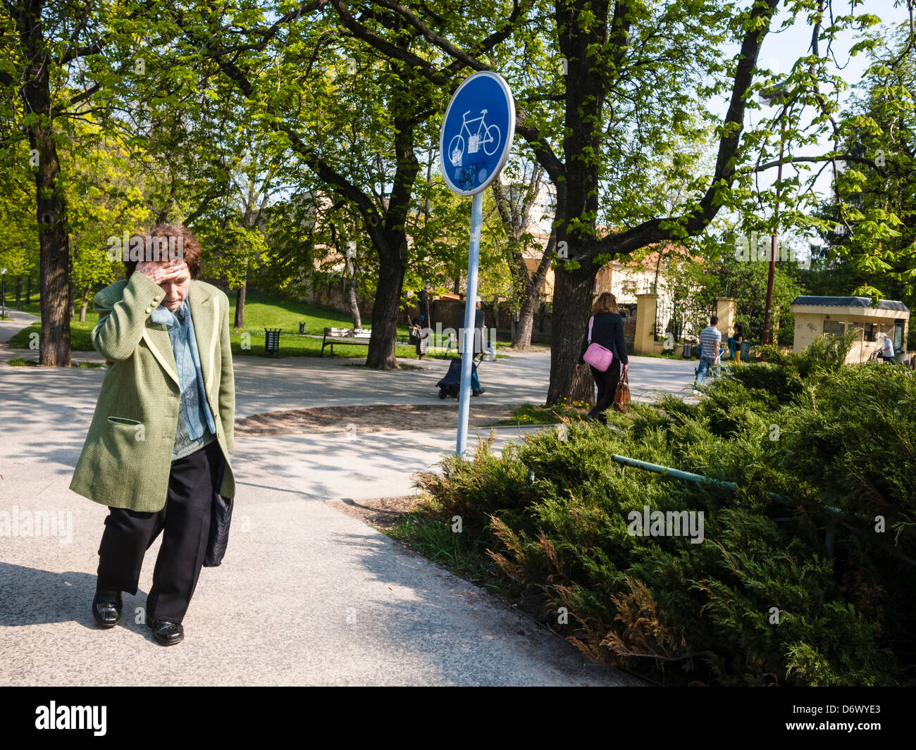 Old tired woman in a park, Trnava, Slovakia Stock Photo