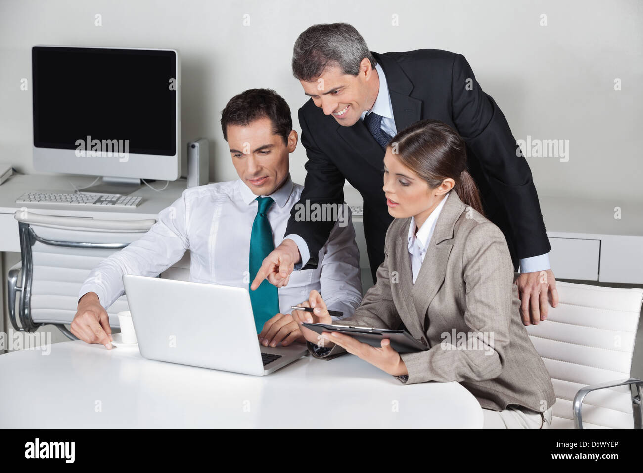 Successful business team working on laptop computer in the office Stock ...