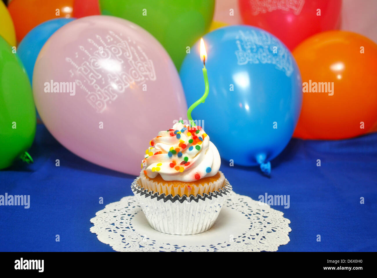 One Lit Candle on a Birthday Cupcake Stock Photo
