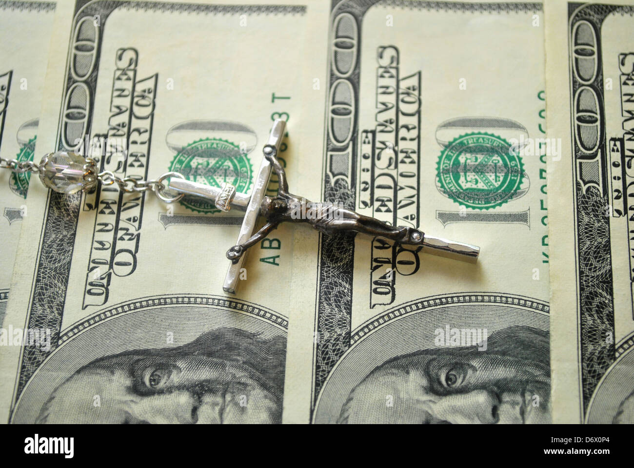 Crucifix on American Money Stock Photo