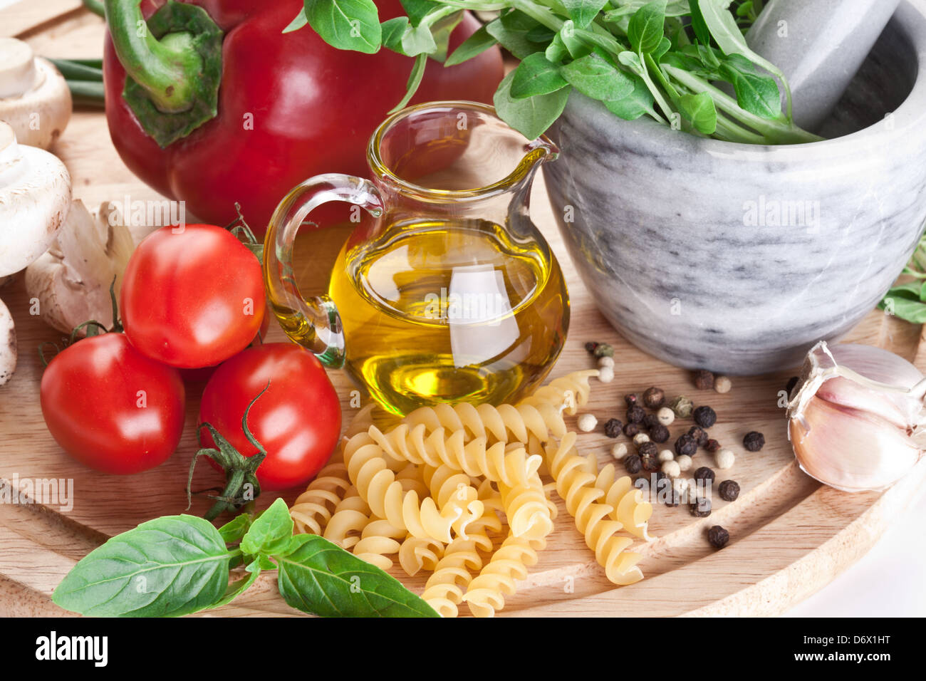 Olive oil, vegetables and herbs. Close-up shot. Stock Photo