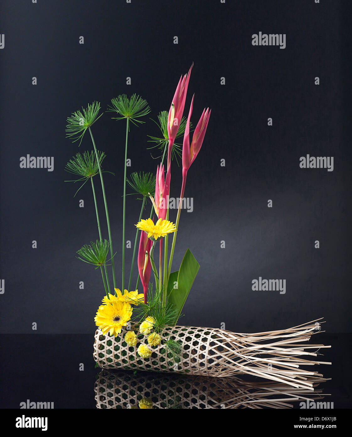 Bamboo basket decorated with bouquet of flowers Stock Photo Alamy