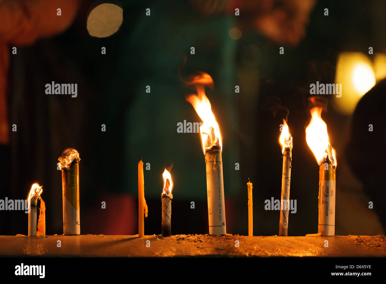 Candles and incense sticks burning for new year eve celebration in Wat