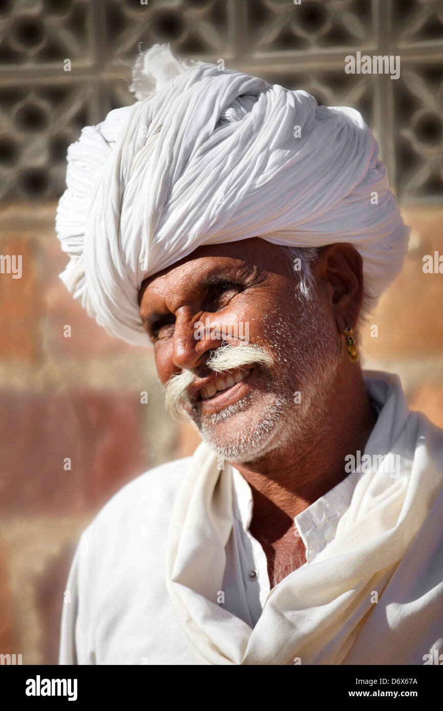 Rajasthani india - portrait of smiling hindu man with moustache wearing white turban Stock Photo