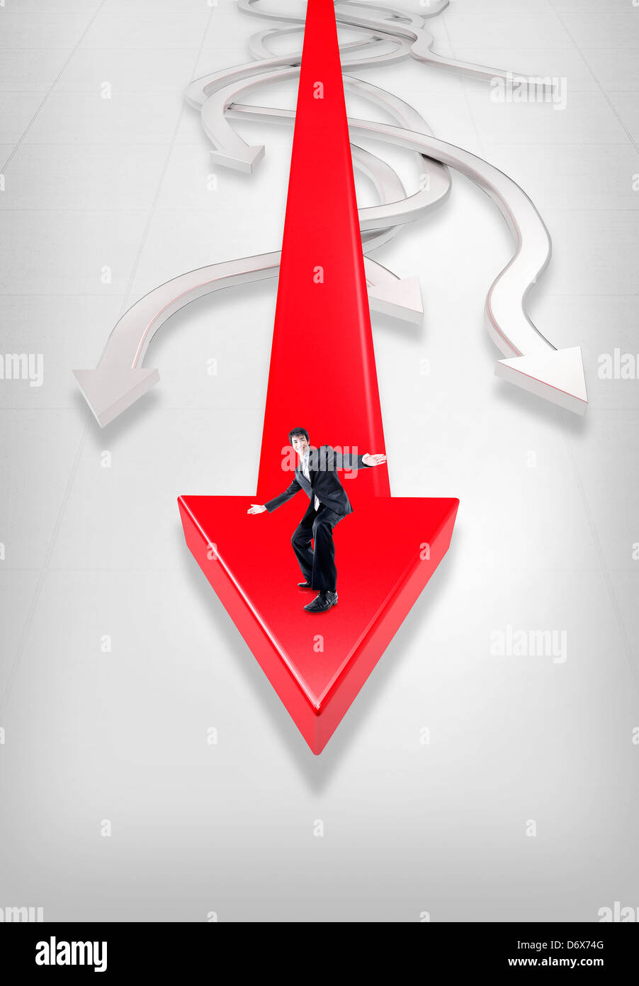 a businessman standing on a red arrow Stock Photo - Alamy