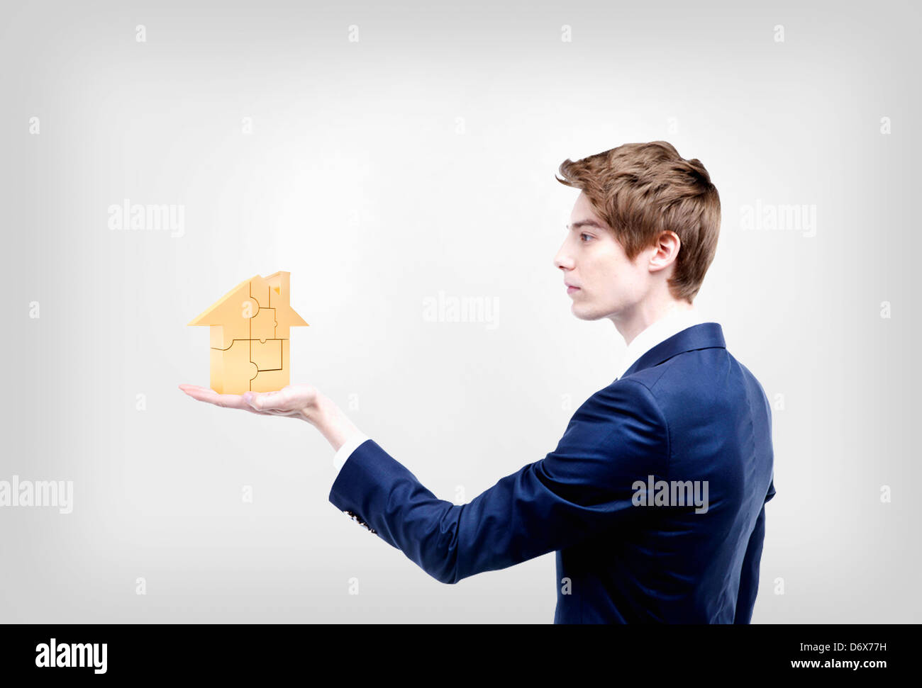 a businessman holding a house on a hand Stock Photo - Alamy