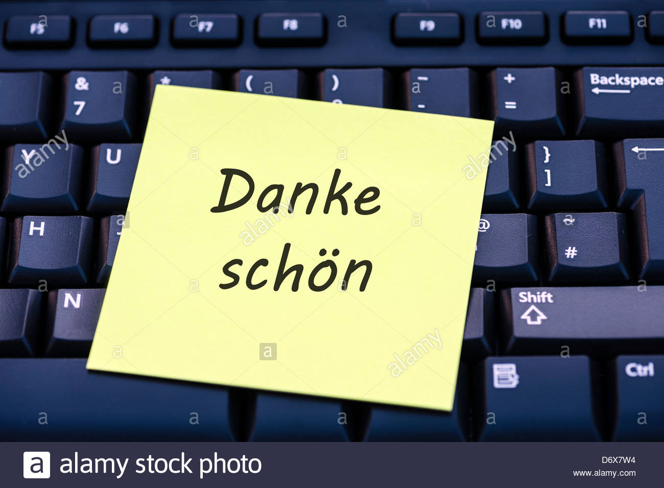 Danke schön written on a sticky yellow post-it note sitting on a Stock ...