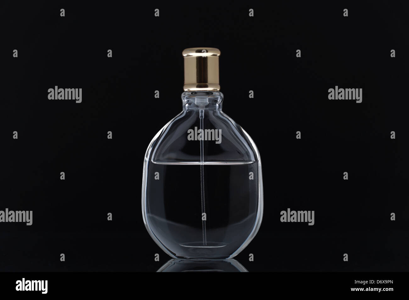 Perfume bottle on black mirror background Stock Photo