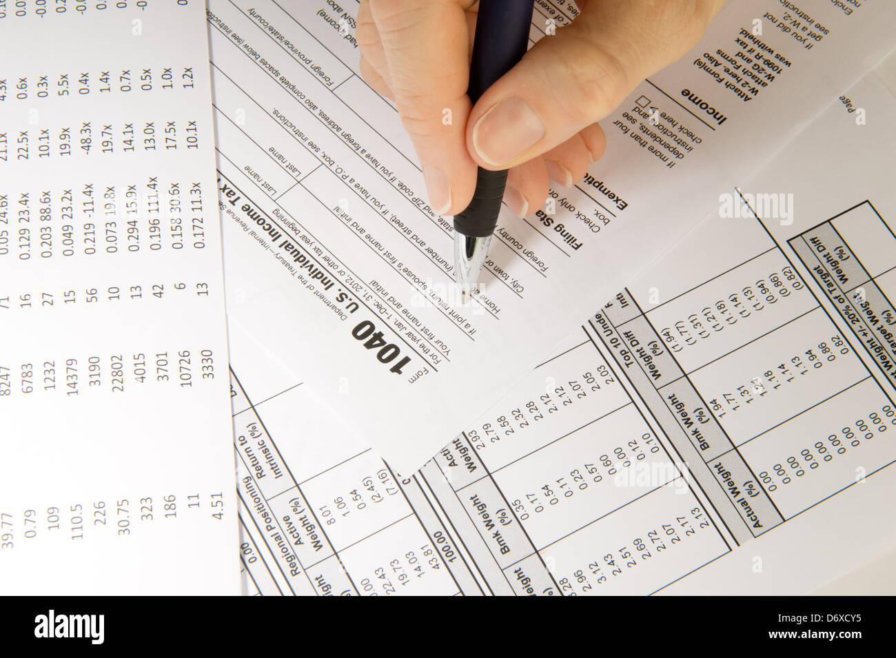 Closeup of hand and pen filling out tax forms Stock Photo