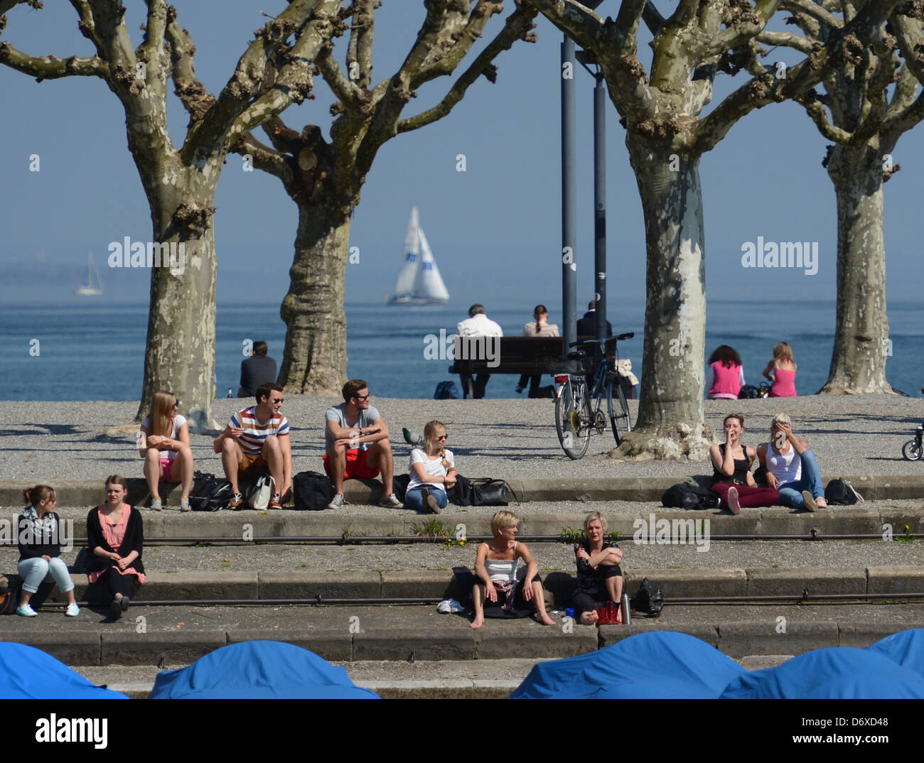 People enjoy the summery temperatures at the lakefront of Lake