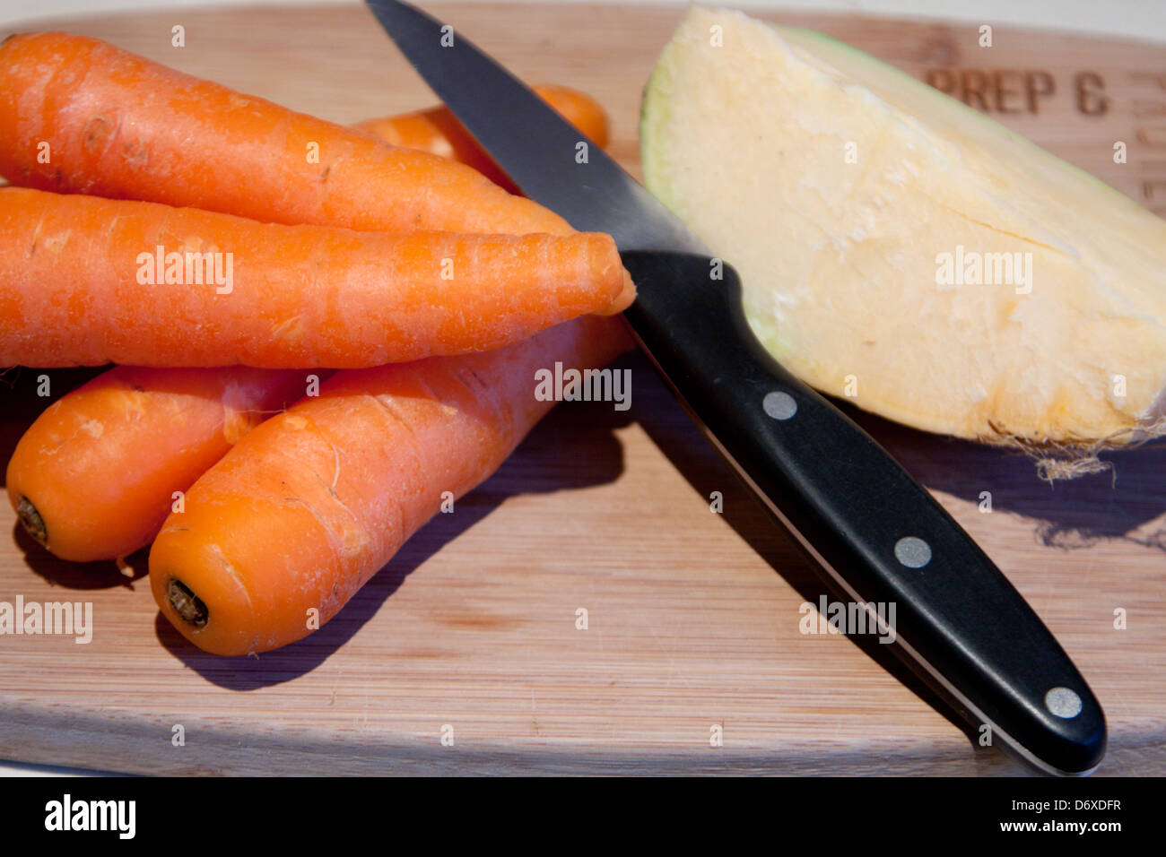 Carrot, swede and knife Stock Photo