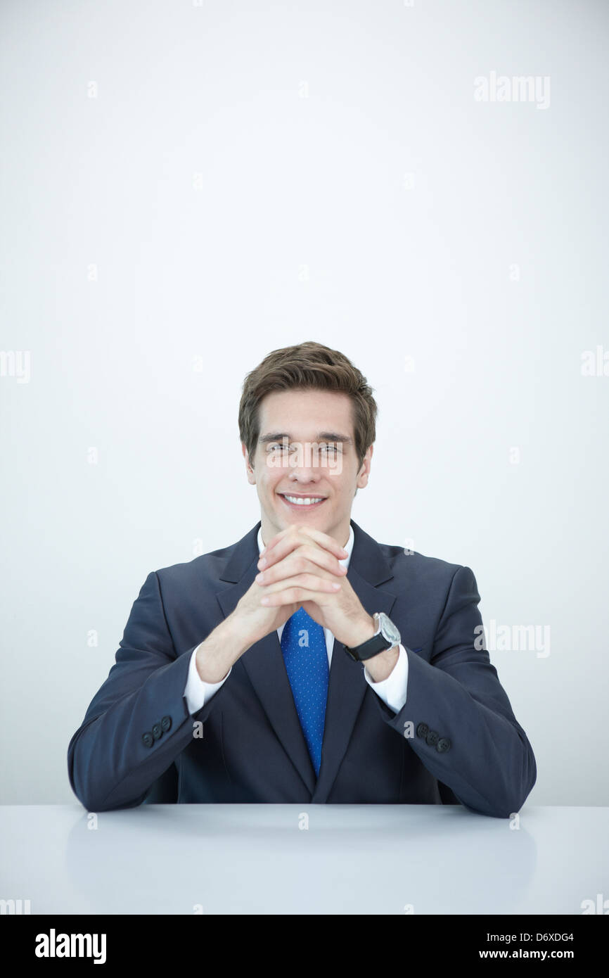 a businessman smiling at a desk Stock Photo - Alamy