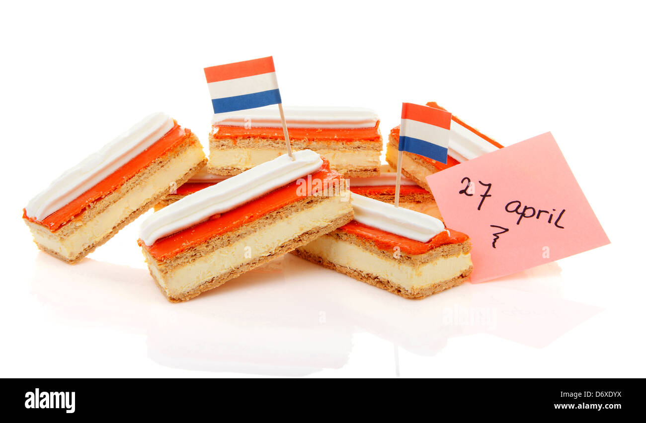 Pile of traditional Dutch pastry called tompouce with flags over white background Stock Photo