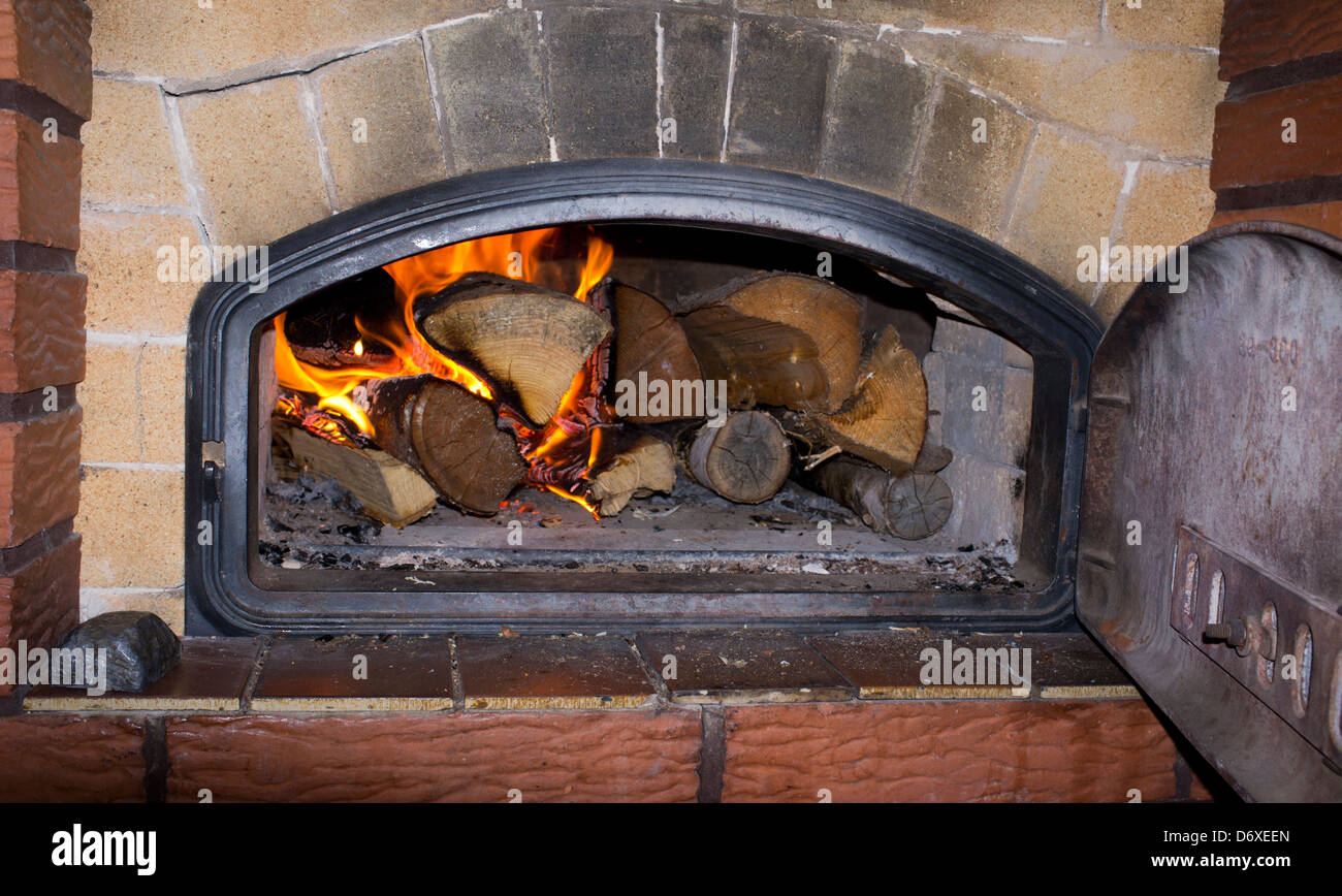 Burning wood inside a fireplace , Finland Stock Photo