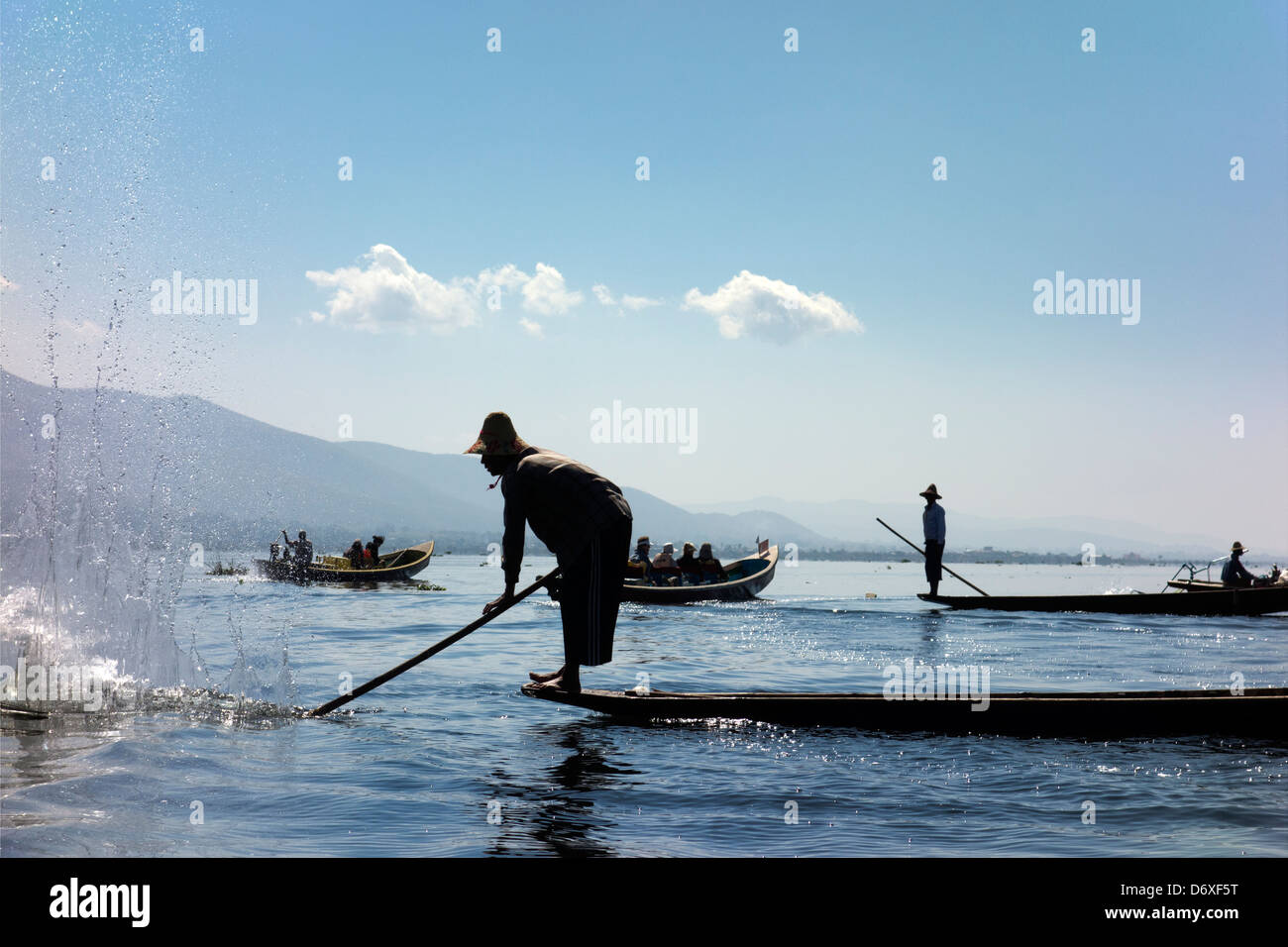 Fisherman beating the water to attract fish on Lake Inle, Myanmar 8 Stock Photo