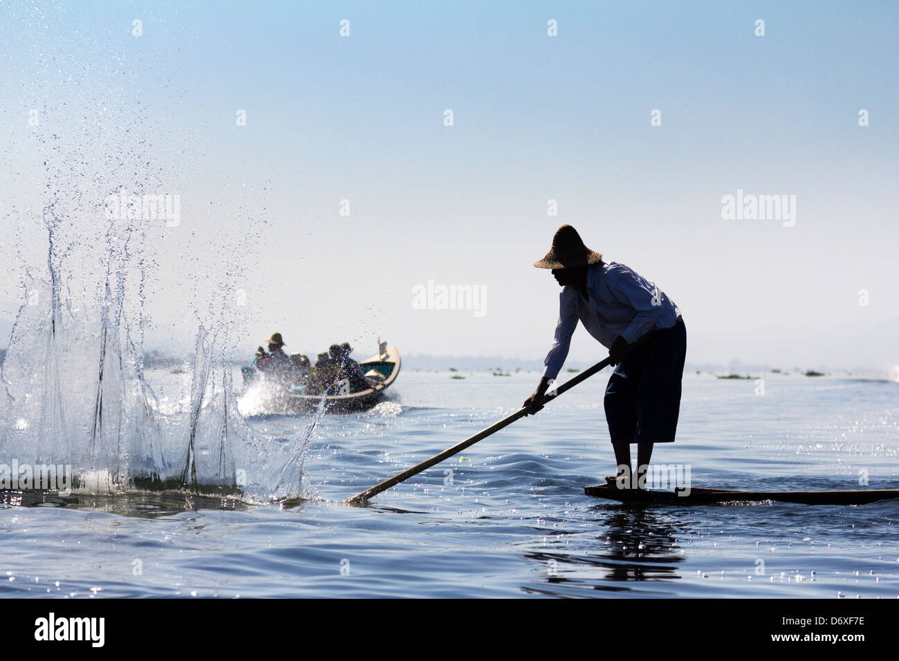 Fisherman beating the water to attract fish on Lake Inle, Myanmar 7 Stock Photo
