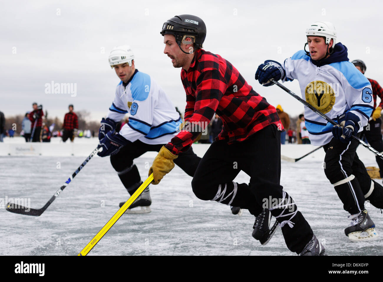Players compete during a game at the U.S. Pond Hockey Championships on Lake Nokomis on January 19, 2013. Stock Photo