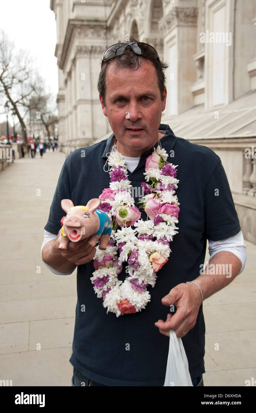 London, UK. 24th April 2013. Mark McGowan, the Artist taxi Driver, famous for his satirical political rants on Youtube, delivers a petition in the form of a letter from his children to 10 Downing Street after pushing a toy pig  with his nose for the 4.1 miles from Kings College Hospital in Camberwell to number 10 Downing Street.  Credit: Pete Maclaine/Alamy Live News Stock Photo