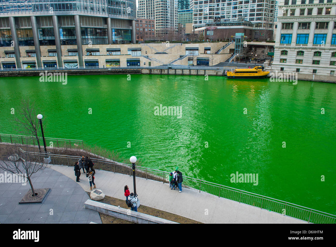 Chicago River is dyed green for St. Patrick's Day. Shadows of bridge  holding crowds of people and flags are imprinted on water surface Stock  Photo - Alamy