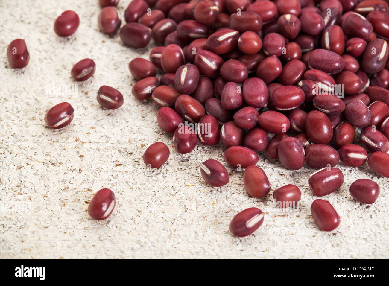 Japanese adzuki (aduki, azuki) beans on a rough white painted barn wood ...