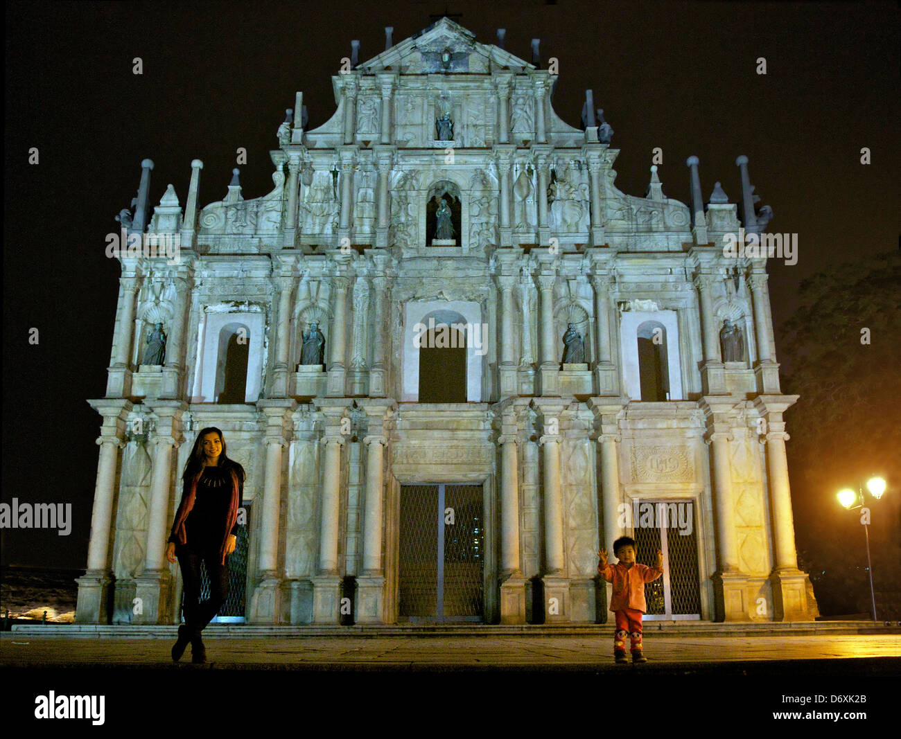 Ruins of St Paul's Church at night with pretty girl posing Macau Stock Photo