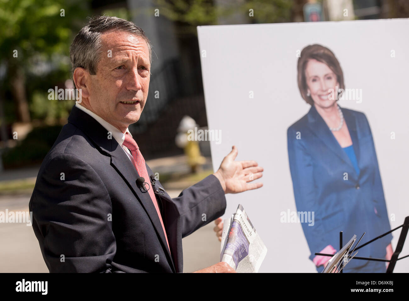 Former South Carolina Governor Mark Sanford debates a cardboard cutout of House Minority Leader Nancy Pelosi during a campaign event on April 24, 2013 in Charleston, South Carolina. Stock Photo