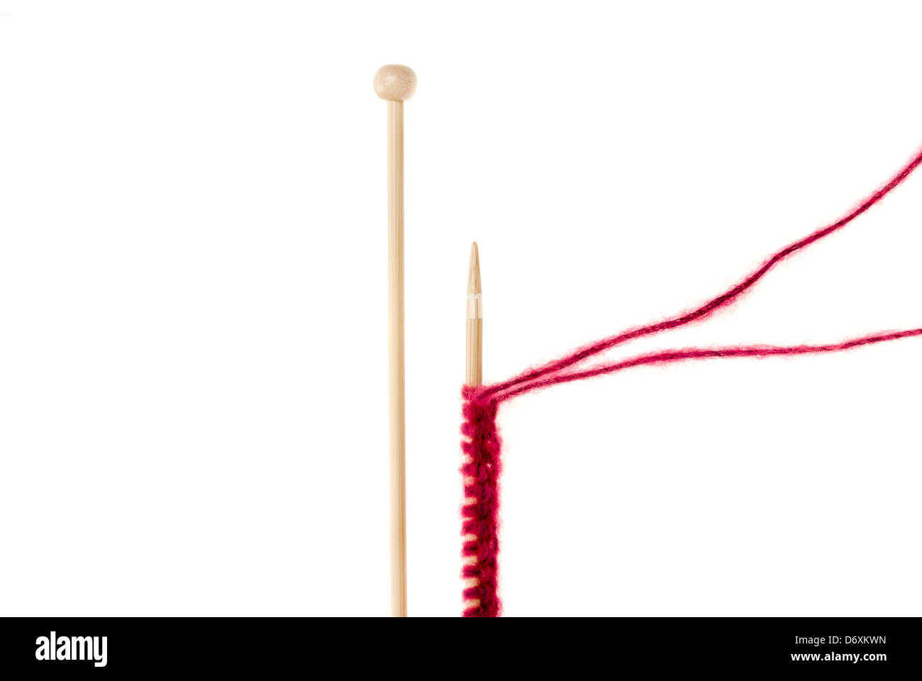 Wooden knitting needles and wool, cast on, isolated on white background Stock Photo