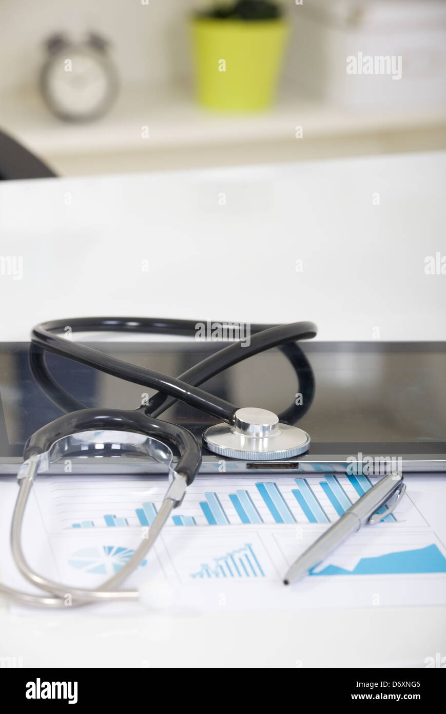 Digital tablet with stethoscope and paperwork Stock Photo - Alamy
