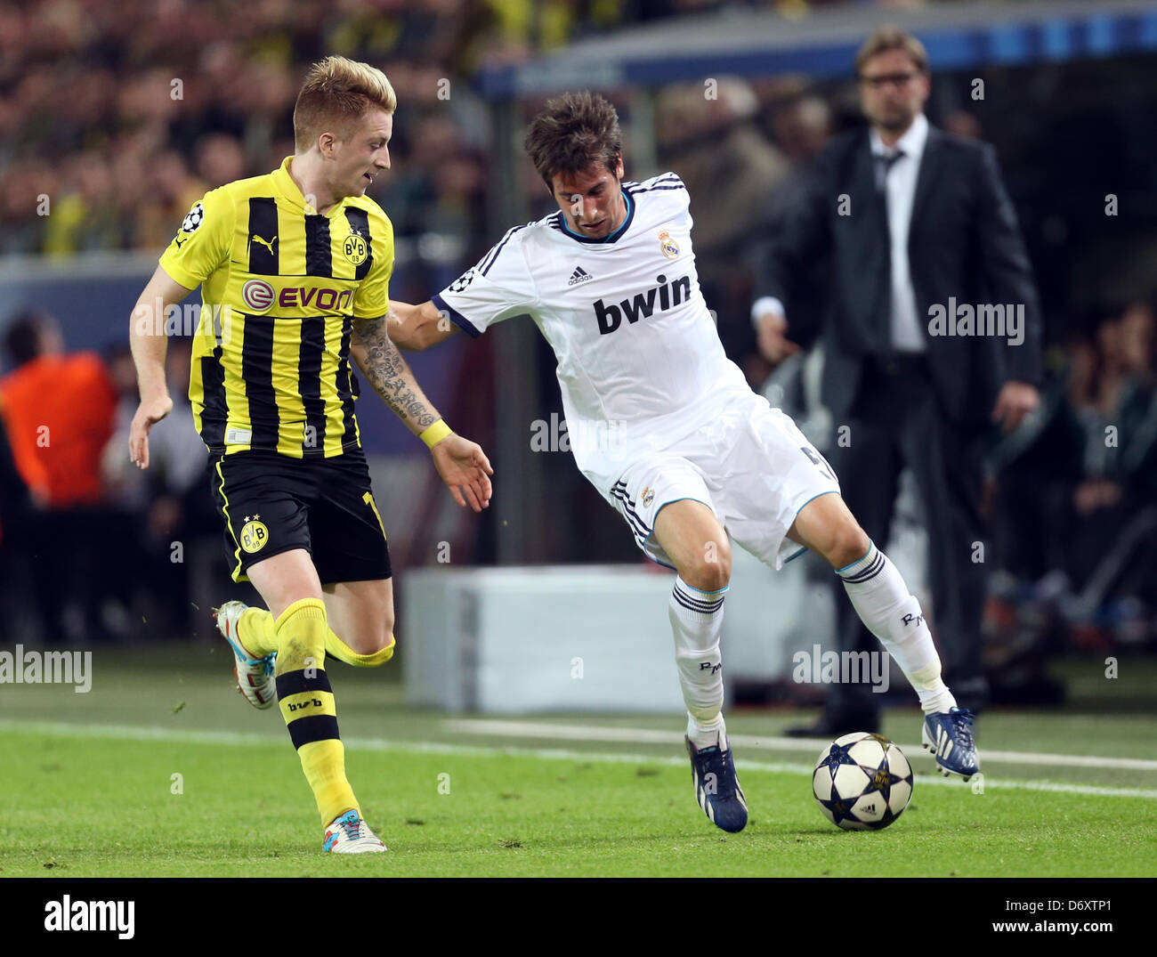 Dortmunds Marco Reus (L) and Madrid's Fabio Coentrao vie for the ball during the UEFA Champions League semi final first leg soccer match between Borussia Dortmund and Real Madrid at BVB stadium Dortmund in Dortmund, Germany, 24 April 2013. Photo: Friso Gentsch/dpa Stock Photo